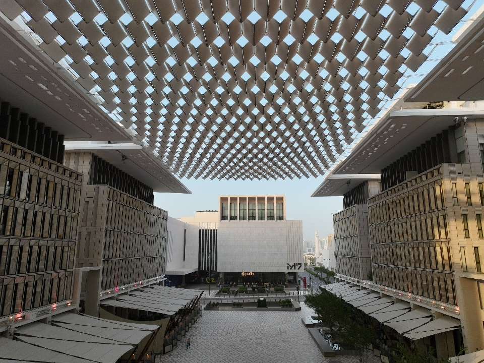 A modern architectural view of M7 Msheireb Downtown a shopping area with a unique patterned roof